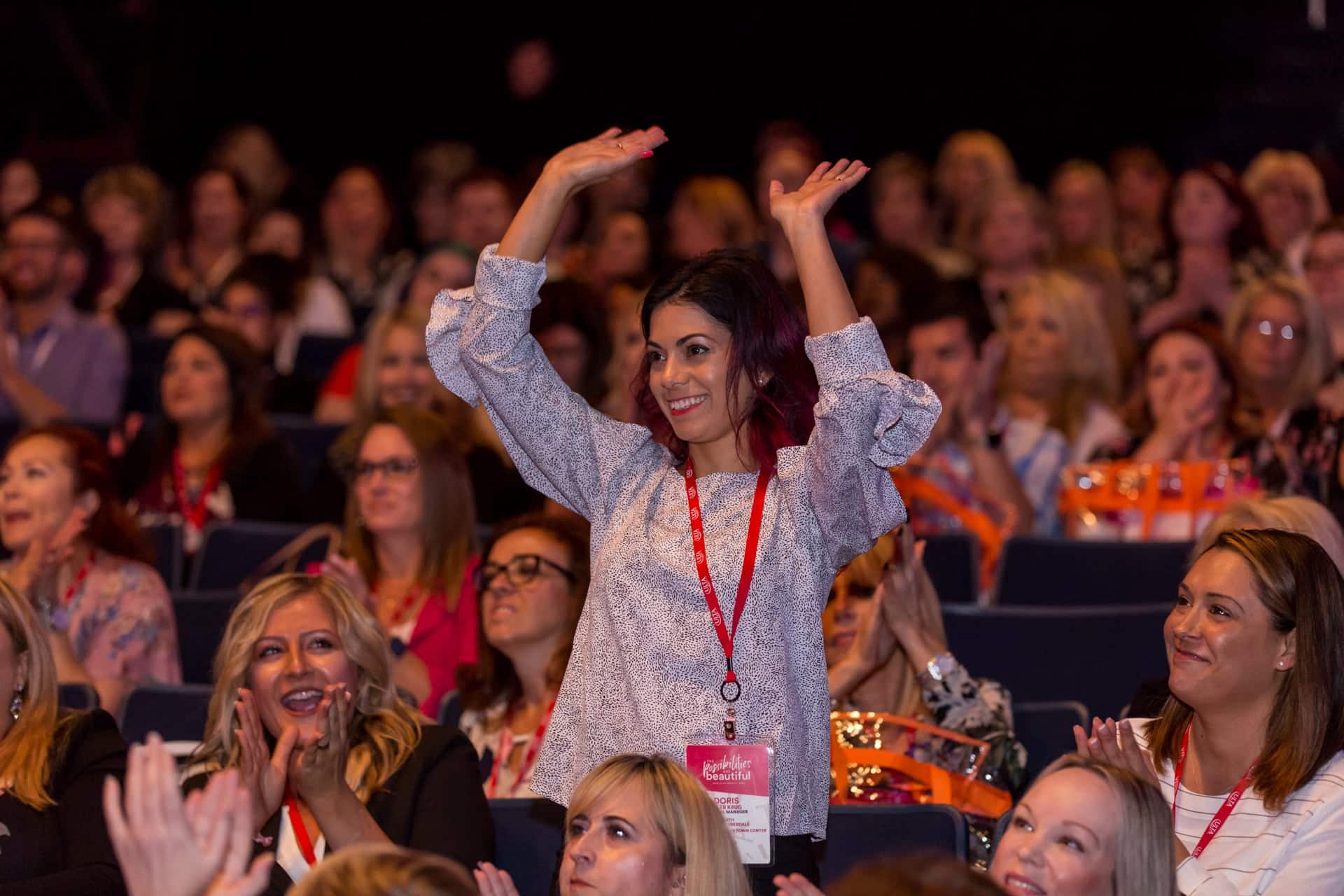 Woman celebrating during a breakout session icebreaker at a corporate event