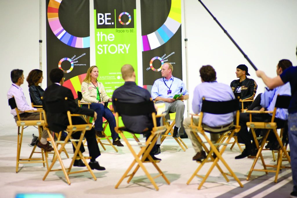 Employees at an event sitting in a circle during discussion