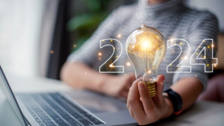 Women holding 2024 with a lightbuld