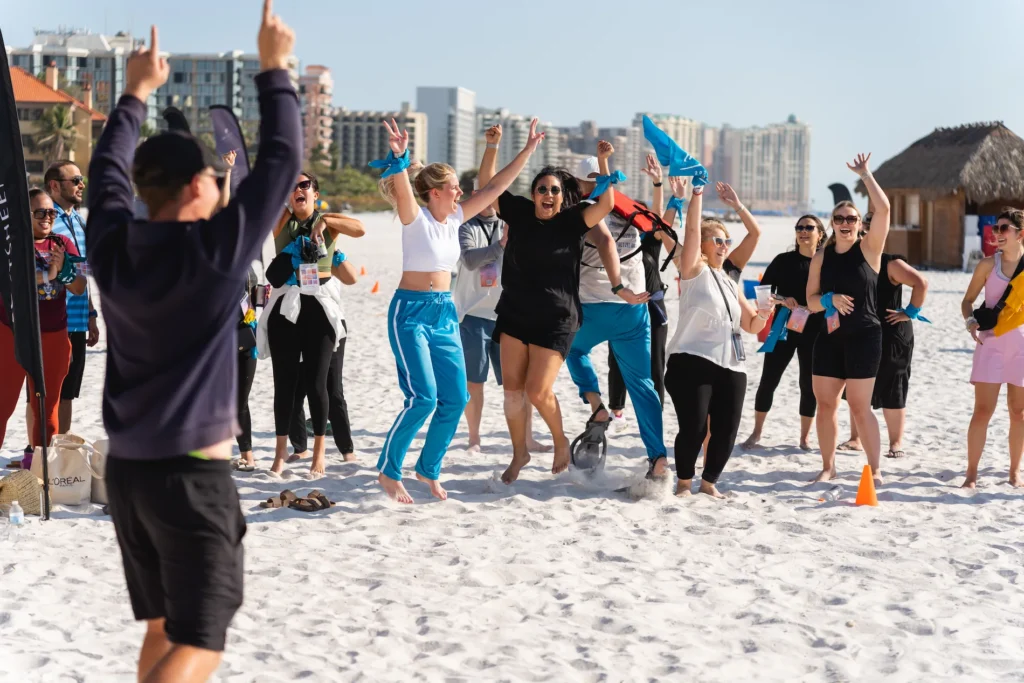 excited employees enjoying company event on a beach